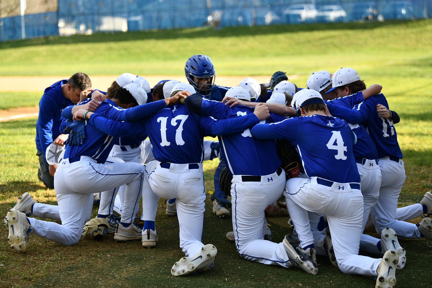 How can I help a high school team process their grief after losing a teammate by suicide?